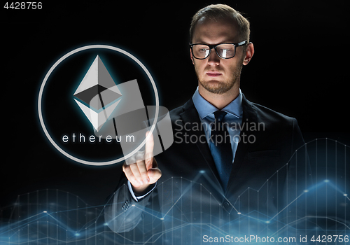 Image of businessman with ethereum hologram over black
