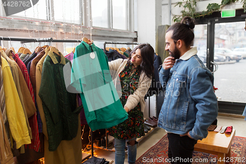 Image of couple choosing clothes at vintage clothing store