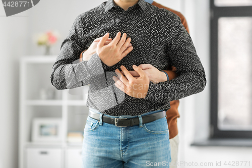 Image of close up of hugging male gay couple