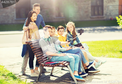 Image of happy teenage students taking selfie by smartphone