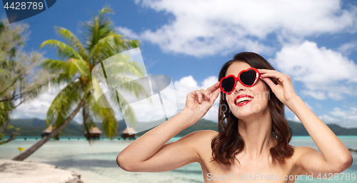 Image of woman with sunglasses over tropical beach