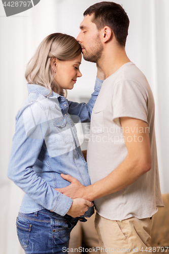 Image of happy man with pregnant woman at home