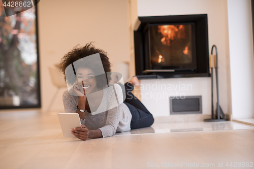 Image of black women using tablet computer on the floor