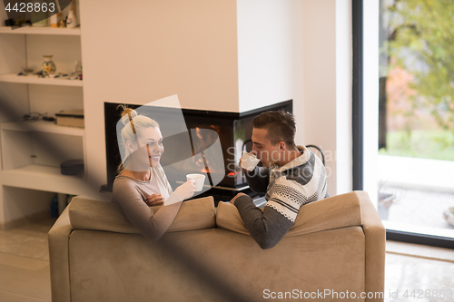 Image of Young couple  in front of fireplace