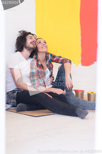 Image of Happy young couple relaxing after painting