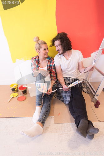 Image of Happy young couple relaxing after painting