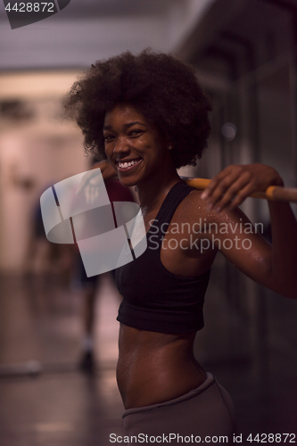 Image of black woman lifting empty bar