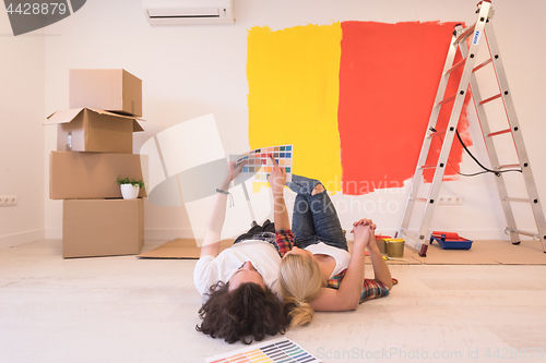 Image of Happy young couple relaxing after painting