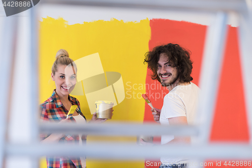 Image of couple painting interior wall