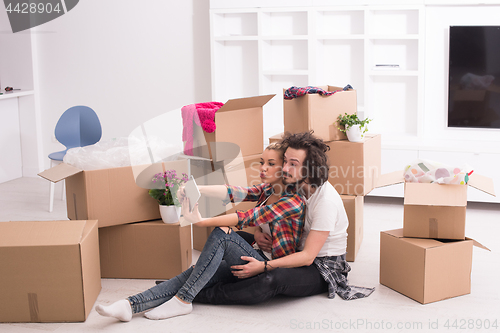 Image of young couple moving  in new house