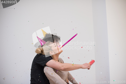 Image of romantic young  couple celebrating  party with confetti