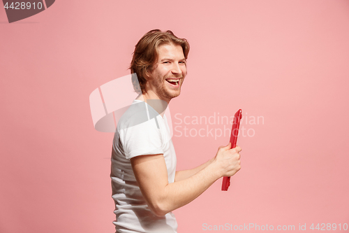 Image of The happy businessman with red laptop on pink
