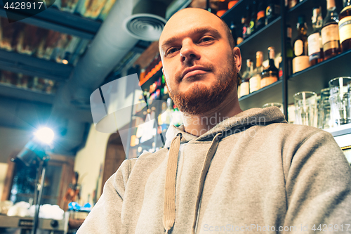 Image of Barman in a pub near beer taps