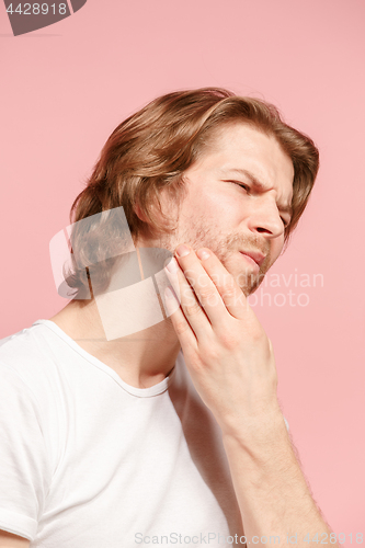 Image of Young man is having toothache.