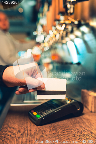 Image of Man using payment terminal