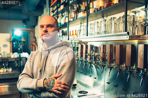 Image of Barman in a pub near beer taps