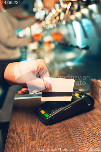 Image of Man using payment terminal