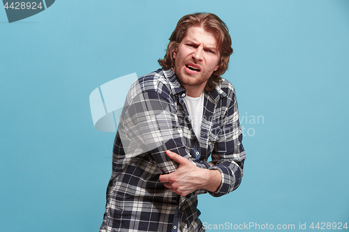 Image of Man With Pain In Elbow. Pain concept