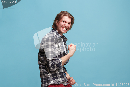 Image of Winning success man happy ecstatic celebrating being a winner. Dynamic energetic image of male model