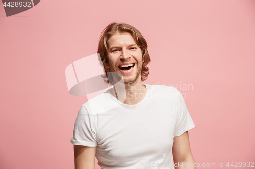 Image of The happy business man standing and smiling against pink background.