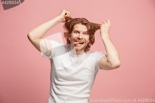 Image of The squint eyed man with weird expression isolated on pink