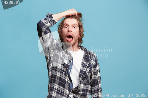 Image of Young man in stress isolated on blue