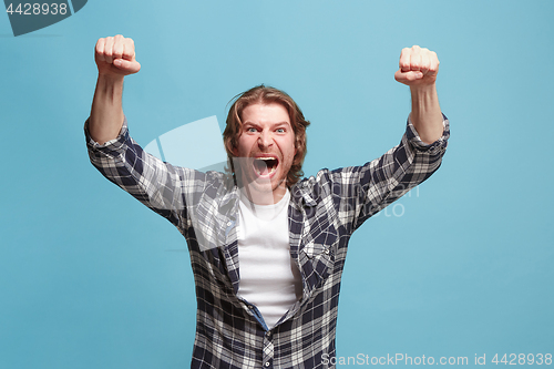 Image of Winning success man happy ecstatic celebrating being a winner. Dynamic energetic image of male model