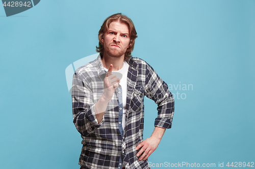 Image of The overbearing business man point you and want you, half length closeup portrait on pink background.