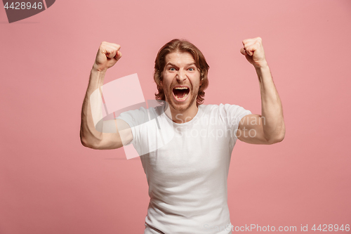 Image of Winning success man happy ecstatic celebrating being a winner. Dynamic energetic image of male model