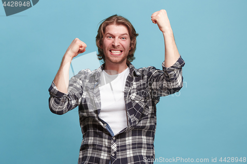 Image of Winning success man happy ecstatic celebrating being a winner. Dynamic energetic image of male model