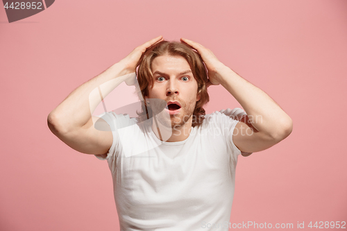 Image of Beautiful man looking suprised isolated on pink