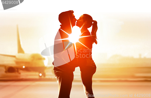 Image of couple of young lovers in airport