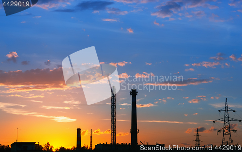 Image of Industrial landscape with silhouettes of towers against the oran