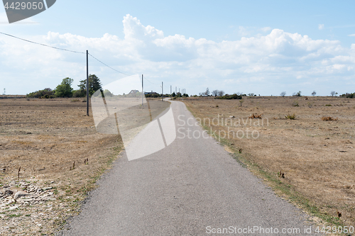 Image of Narrow country road in a dry landscape