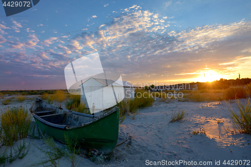 Image of Old fisherman boat at sunset