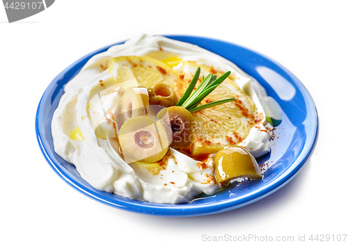 Image of fresh cream cheese with olives and lemon