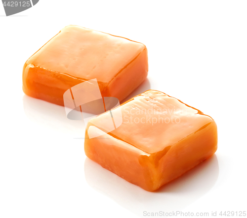 Image of caramel candies on white background