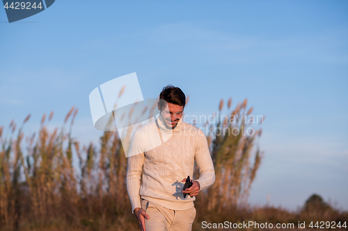 Image of Young man enjoying the warm autumn day
