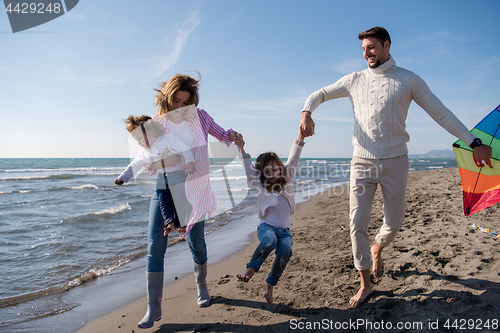 Image of happy family enjoying vecation during autumn day