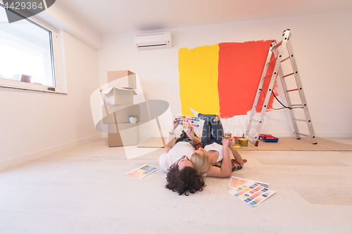 Image of Happy young couple relaxing after painting