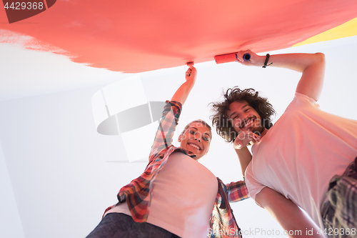 Image of couple painting interior wall