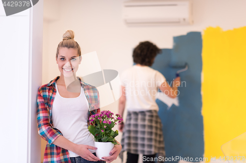 Image of happy young couple doing home renovations