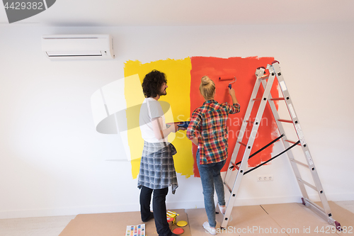 Image of couple painting interior wall