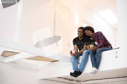 Image of couple having break during moving to new house