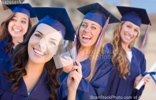 Image of Happy Graduating Group of Girls In Cap and Gown Celebrating on C