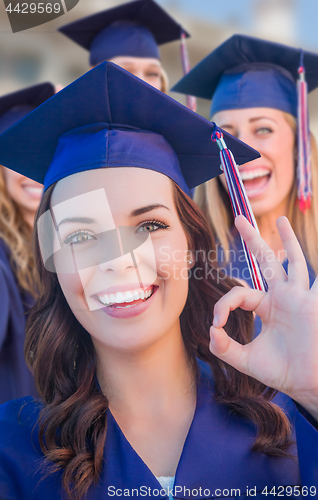 Image of Happy Graduating Group of Girls In Cap and Gown Celebrating on C