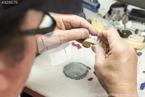 Image of Dental Technician Working On 3D Printed Mold For Tooth Implants