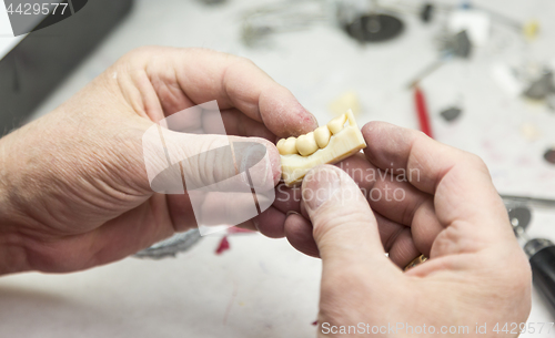 Image of Dental Technician Working On 3D Printed Mold For Tooth Implants