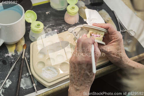 Image of Dental Technician Applying Porcelain To 3D Printed Implant Mold