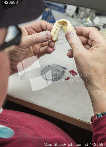 Image of Dental Technician Working On 3D Printed Mold For Tooth Implants